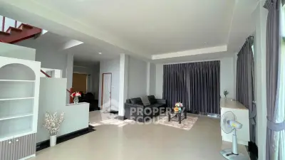 Spacious modern living room with sleek design and ample natural light, perfect for relaxation and entertainment.