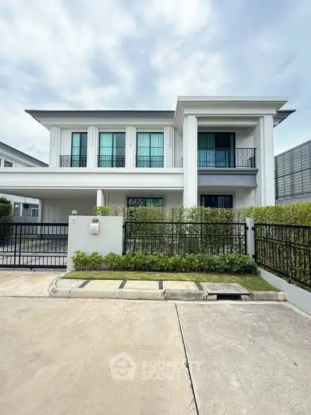 Elegant two-story modern house with balcony and spacious driveway