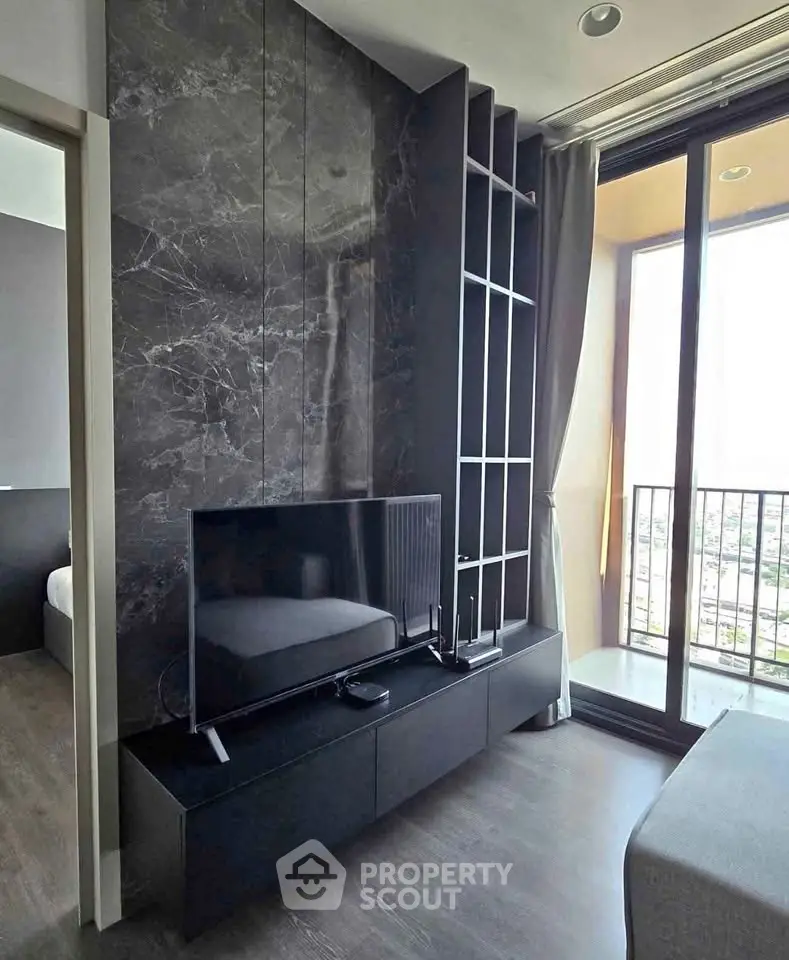 Modern living room with sleek TV unit and floor-to-ceiling windows offering stunning views.