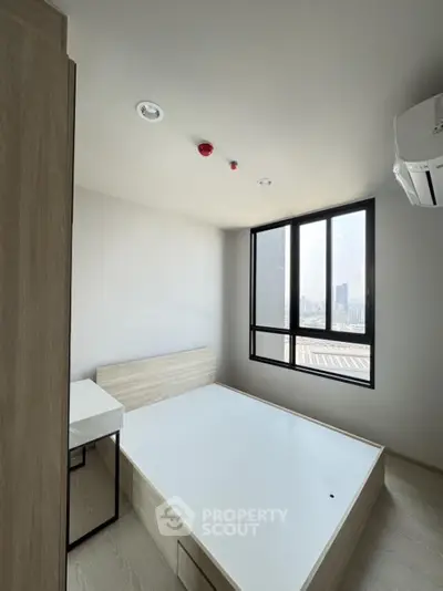 Modern minimalist bedroom with city view and natural light