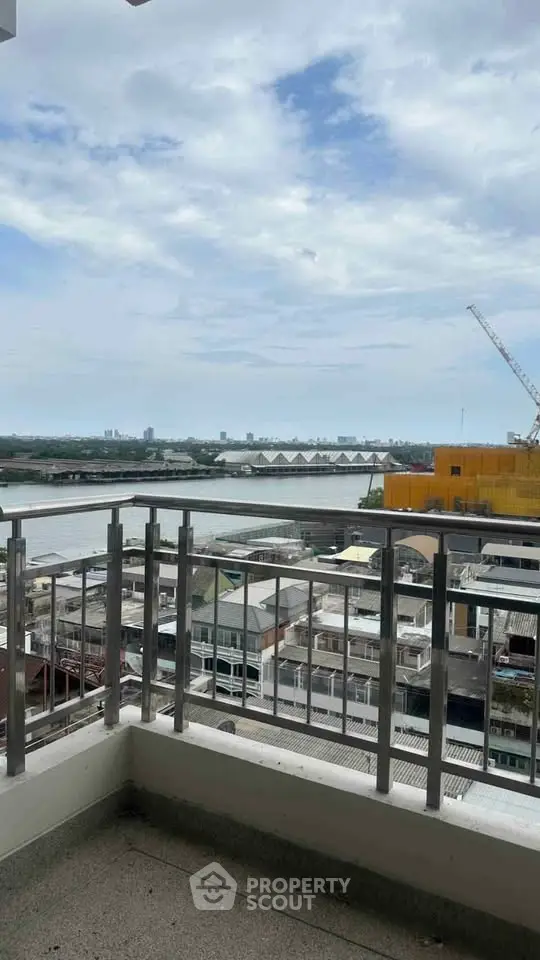 Stunning balcony view overlooking river and cityscape, perfect for urban living.