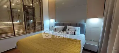 Luxurious bedroom with modern design and ambient lighting, featuring a plush bed and elegant decor.