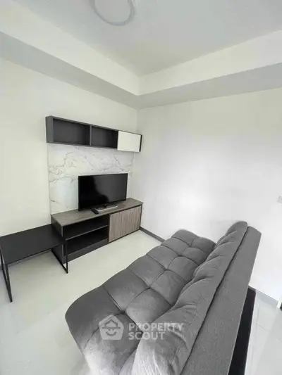 Modern living room with sleek TV unit and stylish sofa in minimalist design.