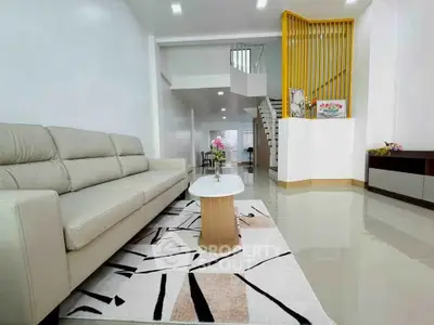 Spacious modern living room with elegant decor and stylish staircase