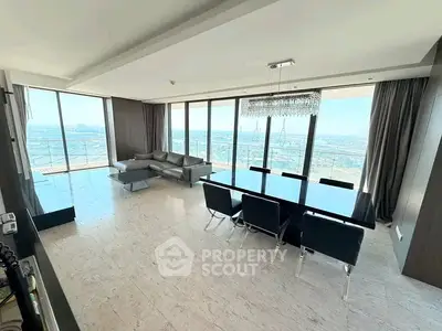 Luxurious living room with panoramic city views and elegant dining area