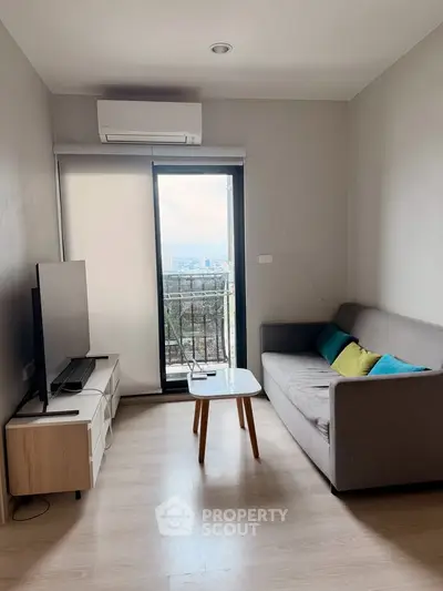 Modern living room with balcony view, featuring sleek furniture and natural light.