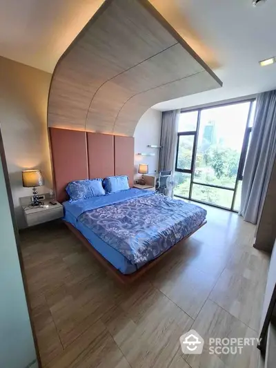 Luxurious bedroom with modern design and large windows offering stunning city views