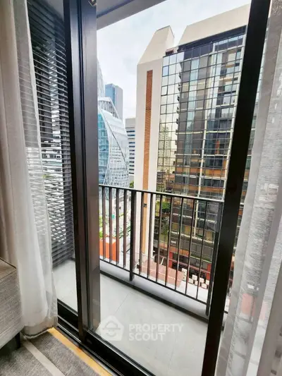 Modern balcony with city view, showcasing sleek architecture and urban lifestyle.