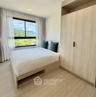 Modern bedroom with scenic view, featuring a cozy bed and sleek wardrobe, perfect for relaxation.