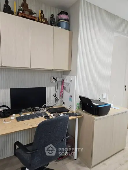 Modern home office with sleek desk, computer setup, and printer in a stylish interior.