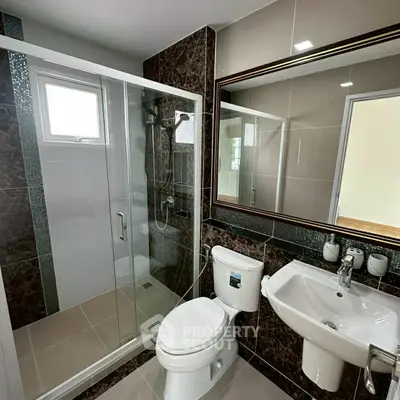 Modern bathroom with glass shower and elegant fixtures