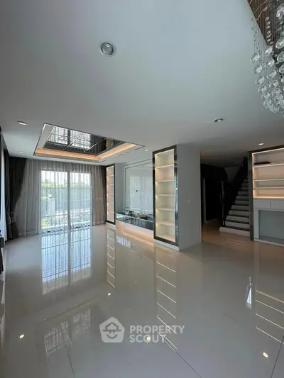 Luxurious modern living room with elegant lighting and large windows for natural light.