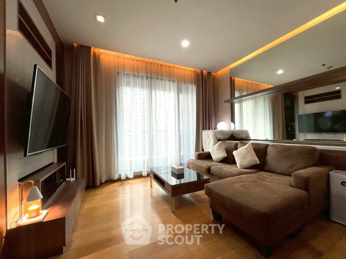 Luxurious living room with modern decor, cozy sofa, and large window offering natural light.