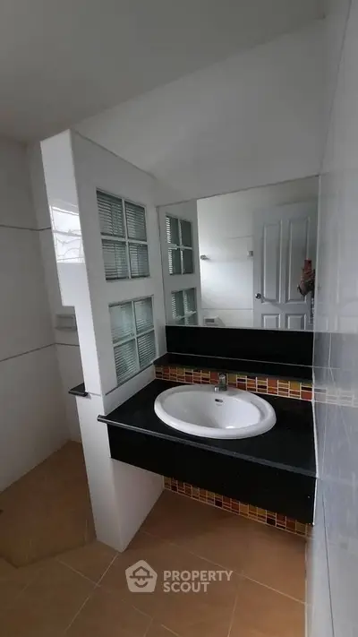 Modern bathroom with stylish sink and mirror in contemporary home