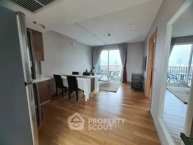 Spacious living room with dining area and balcony view in modern apartment