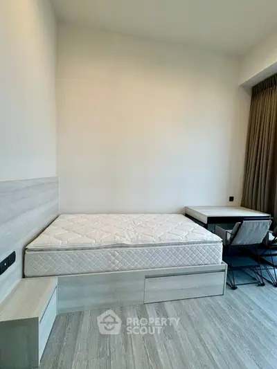 Modern minimalist bedroom with bed and study desk, perfect for urban living.