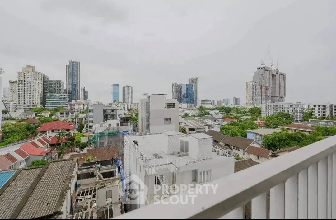 Stunning urban skyline view from a high-rise balcony, showcasing cityscape and modern architecture.