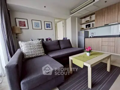 Modern living room with stylish sofa and open kitchen layout