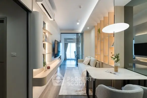 Modern living room with sleek design and ambient lighting, featuring a cozy seating area and stylish shelving.