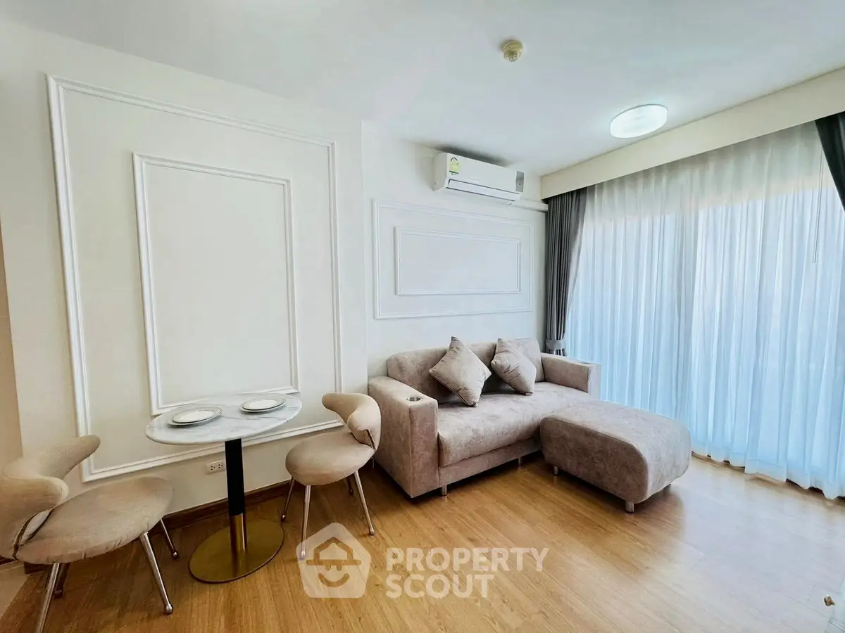 Modern living room with stylish furniture and large window for natural light.
