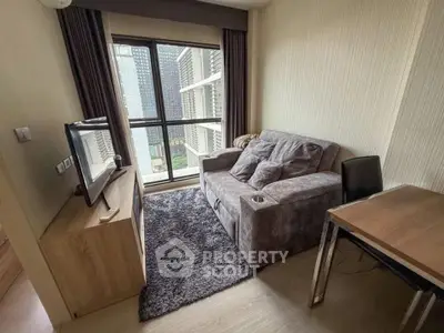 Cozy living room with modern sofa, TV, and city view from window.