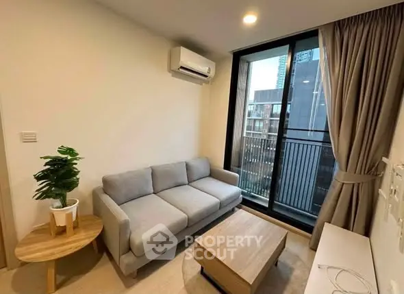 Modern living room with cozy sofa and city view balcony in urban apartment.