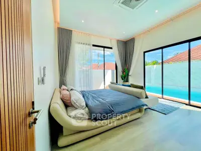 Luxurious bedroom with poolside view and modern decor