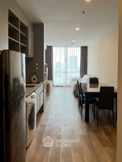 Modern open-plan living space with kitchen, dining area, and city view.