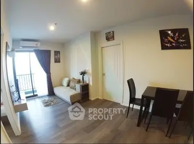 Modern living room with balcony, stylish decor, and dining area in a cozy apartment.