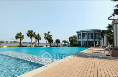 Luxurious poolside view with modern architecture and palm trees, perfect for relaxation and leisure.