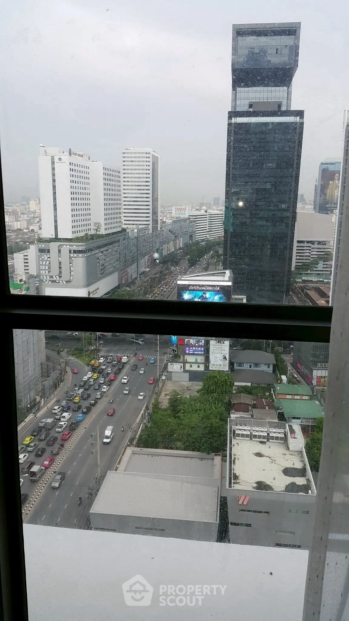 Stunning city view from high-rise building window with bustling street below.