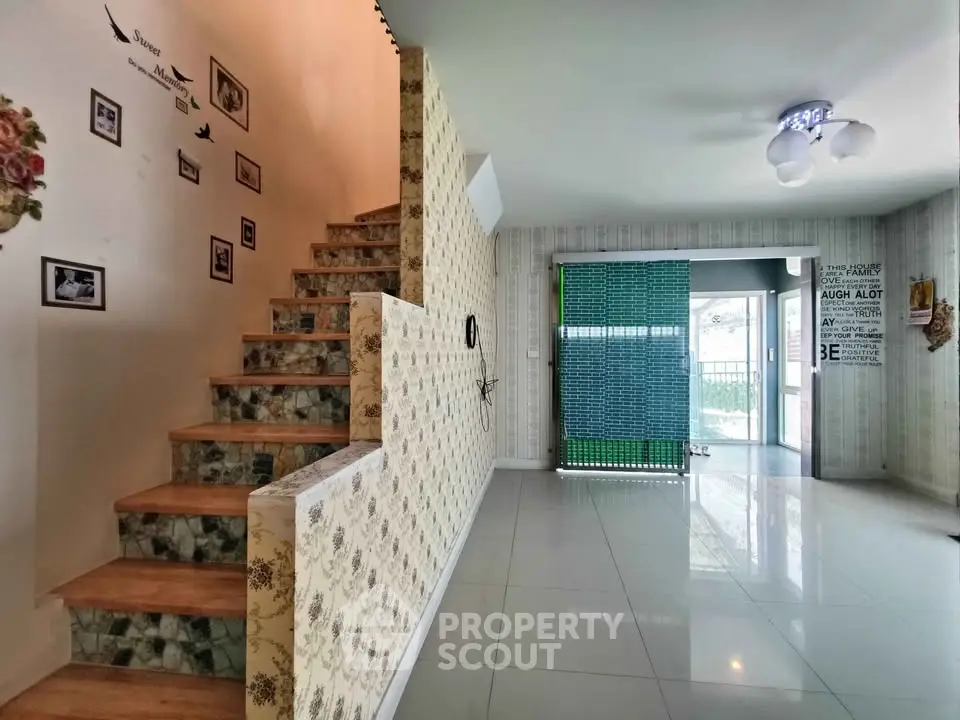 Stylish modern interior with staircase and open living area, featuring elegant decor and natural light.