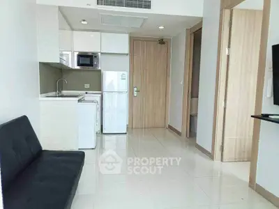 Modern apartment interior with compact kitchen and cozy living area