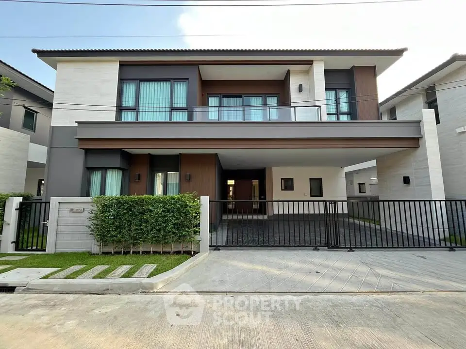 Modern two-story house with sleek design and spacious driveway in a serene neighborhood.