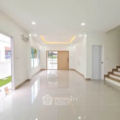 Spacious modern living room with glossy tile flooring and recessed lighting.
