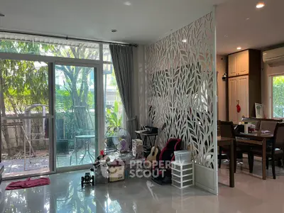 Spacious living room with garden view and stylish partition in modern home