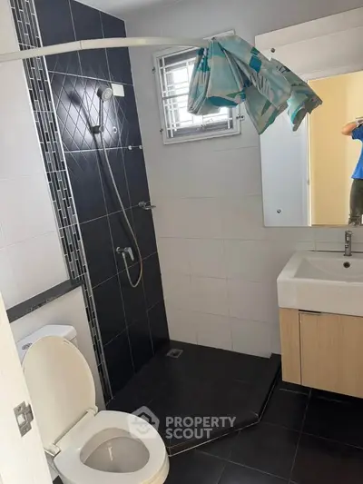 Modern bathroom with sleek black tiles and stylish fixtures
