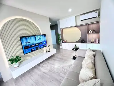 Modern living room with stylish decor and wall-mounted TV, featuring elegant lighting and sleek furniture.