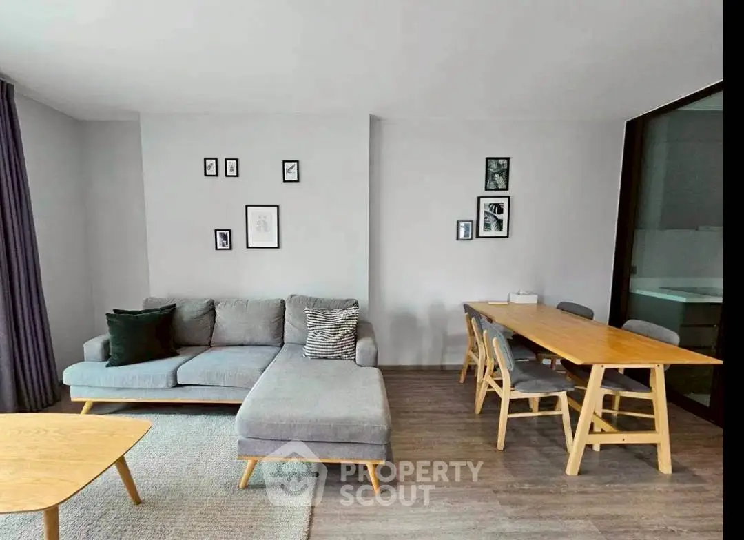 Modern living room with stylish furniture and dining area, perfect for urban living.