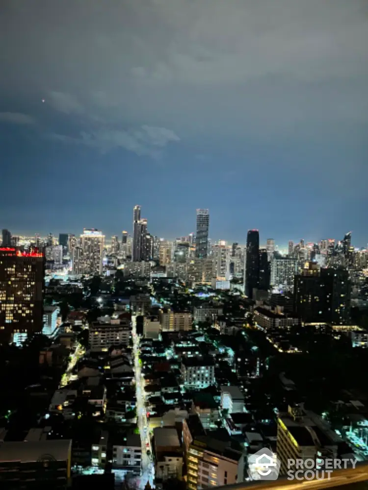 Stunning city skyline view from high-rise apartment balcony at night