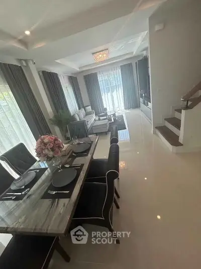 Elegant living room with modern dining area and stylish decor