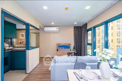 Modern living room with open kitchen and large windows in a stylish apartment