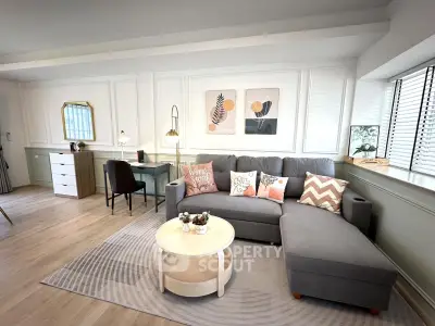 Stylish living room with modern decor, cozy sofa, and elegant workspace in a bright, inviting setting.