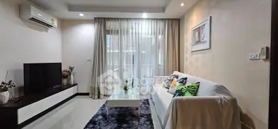 Modern living room with stylish decor, cozy sofa, and sleek entertainment unit in a bright, inviting space.