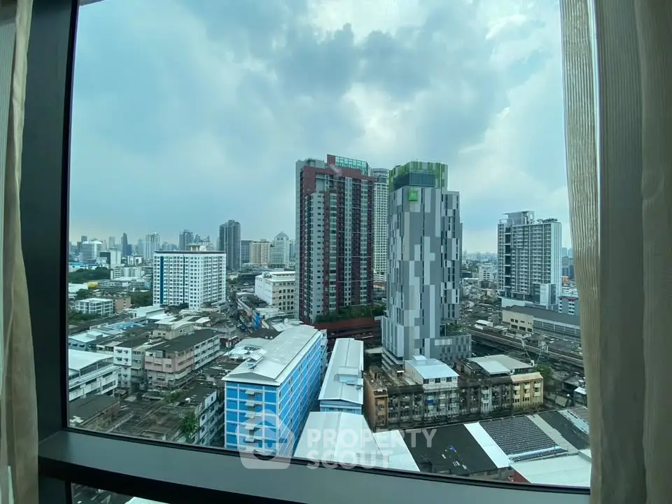 Stunning cityscape view from high-rise apartment window showcasing modern urban architecture.