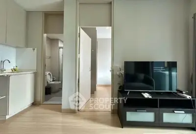 Modern living room with TV and open kitchen in stylish apartment