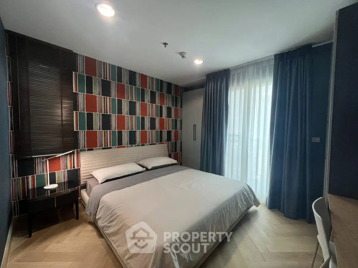 Modern bedroom with stylish geometric accent wall and cozy lighting