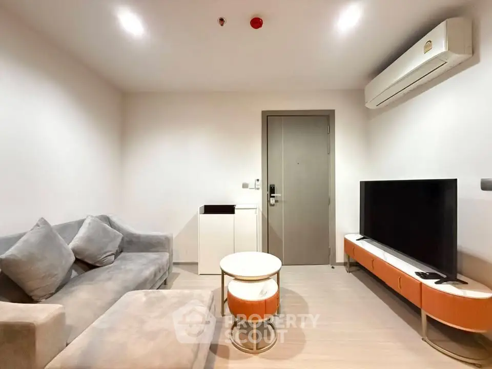 Modern living room with sleek furniture and air conditioning in a cozy apartment.