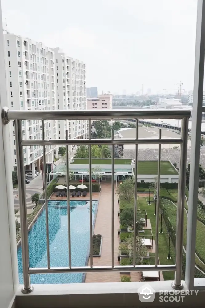 Stunning balcony view overlooking modern pool and cityscape in high-rise building.