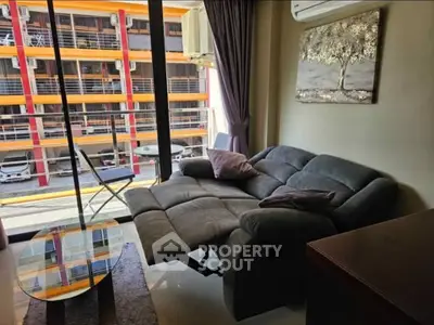 Modern living room with reclining sofa and balcony view